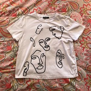 White top with faces